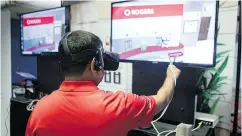  ?? CHRIS YOUNG / THE CANADIAN PRESS FILES ?? A Rogers staffer wears VR goggles as he stands at a stall promoting VR retail over 5G last month in Toronto.