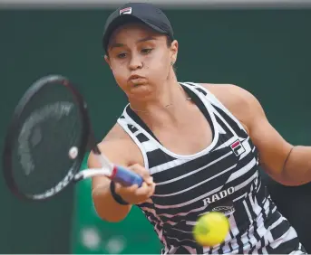  ?? Picture: AFP ?? FIGHTER: Ash Barty returns during her win against Amanda Anisimova last night.