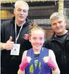  ??  ?? Fighting talk Chloe, pictured with her coaches, wants to win gold for Scotland