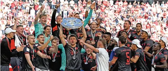  ?? ?? Bayern Munich players celebrate with the Bundesliga trophy on Saturday (AFP)