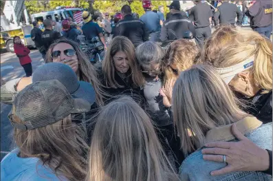  ?? APU GOMES | AFP/GETTY IMAGES ?? MOURNERS gather outside the Los Robles Medical Center in Thousand Oaks, Calif., on Thursday to pay tribute to Ventura County sheriff Sgt. Ron Helus, who was among 12 people killed at the Borderline Bar the night before. Helus, responding to the scene, was killed as he rushed inside.