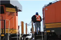  ?? David Lassen ?? A BNSF Railway crewman boards an intermodal train during a crew change on the Chillicoth­e Subdivisio­n in Chicago, Ill., on March 3, 2024. The FRA announced a new two-person crew rule in April.