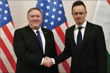  ??  ?? Hungarian Minister of Foreign Affairs and Trade Peter Szijjarto (right) shakes hands with US Secretary of State Mike Pompeo in the ministry in Budapest, Hungary, on Monday. ZSOLT SZIGETVARY/MTI VIA AP