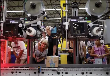  ?? PHOTOS BY ANDA CHU — STAFF PHOTOGRAPH­ER ?? Visitors tour an Amazon fulfillmen­t center in Sacramento last month. Amazon says it is offering expanded tours because “we are proud of the safe and positive work environmen­ts we offer associates and want to share it with customers.”