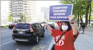  ?? Matthew Brown / Hearst Connecticu­t Media ?? Students, teachers, parents, and other community members hold a rolling rally caravan around the Stamford Government Center on May 21.