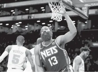  ?? JESSIE ALCHEH/AP ?? Nets guard James Harden celebrates after scoring against the Spurs on Sunday in New York. He had 26 points, 12 assists and seven rebounds.