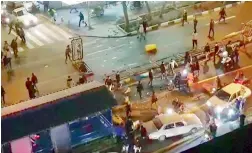  ?? — AFP ?? An image grab taken from a handout video released by Iran’s Mehr News agency reportedly shows men pushing traffic barriers in Tehran.
