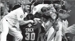  ?? ANDY LYONS/GETTY ?? Members of the Pirates and Reds fight during a bench-clearing altercatio­n Tuesday.