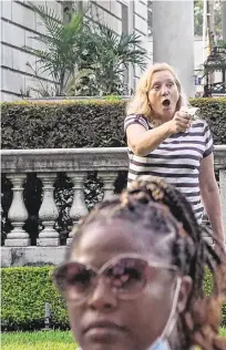  ?? PHOTOS: REUTERS ?? Tensions rising: A couple point their firearms at marchers during a protest against Ms Krewson.