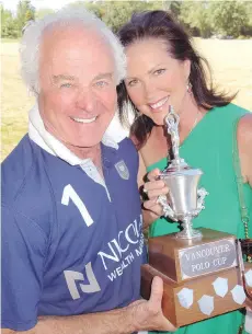  ??  ?? Seen at Southlands Riding Club with wife Suzanne, Pacific Polo Cup player Gery Warner handed over a Vancouver Polo Cup he won in 1989.