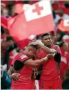  ??  ?? Daniel Tupou celebrates with his Tongan team-mates.