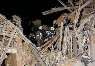  ?? KHARKIV REGIONAL ADMINISTRA­TION PHOTO VIA AP ?? DAMAGED DWELLING
Emergency workers work at an apartment damaged in a Russian rocket attack in the city of Kharkiv, eastern Ukraine on Wednesday, Jan. 17, 2024.