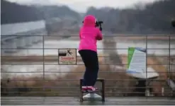  ??  ?? PAJU: In this file photo, a girl uses binoculars to watch the North side at the Imjingak Pavilion near the border village of Panmunjom, which has separated the two Koreas since the Korean War, in Paju, South Korea.—AP