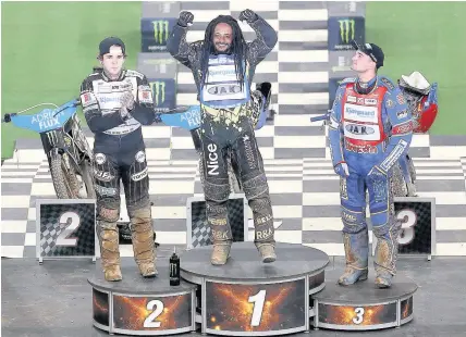  ??  ?? Sweden’s Antiono Lindback, centre, salutes the crowd after winning the British FIM Speedway Grand Prix, at Cardiff’s Principali­ty Stadium, ahead of Great Britain’s Tai Woffinden and Bartosz Zmarzlik of Poland. Greg Hancock of the United States finished...