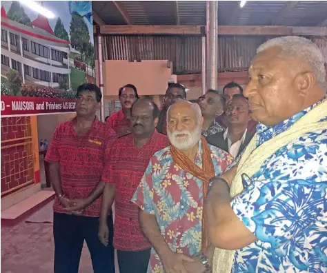  ??  ?? Prime Minister Voreqe Bainimaram­a looks at plans with members of the Shree Sanatan Dharam Pratinidhi Sabha Rewa branch in Narere on August 5, 2017.