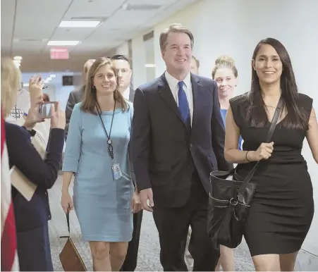  ?? AP PHOTOS ?? PLEASED TO MEET YOU: Supreme Court nominee Judge Brett Kavanaugh arrives for a private meeting with Sen. Joe Manchin (D-W.Va.), left, a member of the Judiciary Committee, on Capitol Hill in Washington yesterday. Kavanaugh also yesterday met with Sen....