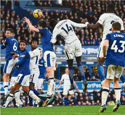  ??  ?? Up for it: Chelsea’s Tiemoue Bakayoko (centre) contesting a header with Everton’s Michael Keane during the English Premier League match at Goodison Park on Saturday. — AFP