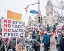  ?? BRETT GUNDLOCK/THE NEW YORK TIMES ?? Protesters gather Friday in Ottawa, Ontario, where they are demanding an end to vaccine mandates and coronaviru­s restrictio­ns.