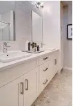  ??  ?? The ensuite features dual sinks, a linen closet and durable linoleum flooring.