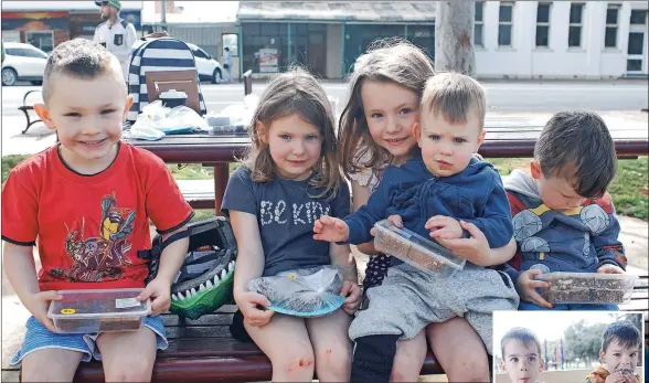  ?? ?? Sweet sensation: Kenzie, Faith, Harper (holding Cooper) and William Van Roys at the Tongala Developmen­t Group’s street stall on Saturday morning. Jax and Seth Aitchison, right, had a perfect start to their morning when they shared the chocolate and strawberry flavoured delights of the stall.