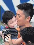  ??  ?? That’s my boy: Japan’s keeper Eiji Kawashima greets his son Kensei after the game