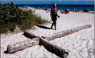  ?? TRIBUNE NEWS SERVICE ?? A large cross washed ashore over the weekend behind a hotel along Galt Ocean Mile in Fort Lauderdale.