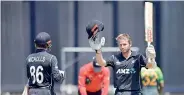  ?? ?? New Zealand's captain Kane Williamson (R) celebrates 100 runs with teammate Henry Nicholls against Pakistan in Wellington - AFP