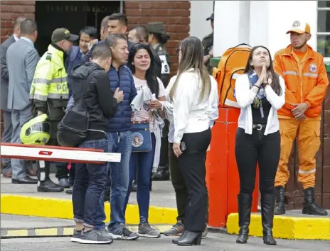  ?? John Wilson Vizcaino/Associated Press ?? Family members of victims of a bombing gather outside the entrance to the General Santander police academy where the bombing took place Thursday in Bogota, Colombia.