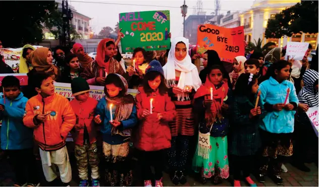 ?? Agence France-presse ?? ↑ Children light candle to welcome the New Year in Lahore on Tuesday.