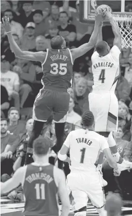  ?? RAY CHAVEZ/STAFF PHOTOS ?? The Warriors’ Kevin Durant blocks a shot by the Trail Blazers’ Maurice Harkless in the first quarter of Game 4 on Monday night in Portland, Ore.