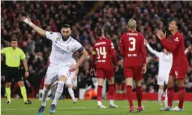  ?? Photograph: Paul Greenwood/Colorsport/Shuttersto­ck ?? Karim Benzema celebrates scoring as Liverpool players reacted in dismay at Anfield.