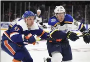  ?? KATHLEEN MALONE-VAN DYKE ?? St. Louis Blues left wing Mackenzie MacEachern (28) and New York Islanders right wing Leo Komarov (47) battle for possession during the first period of an NHL hockey game, Monday, Oct. 14, 2019, in Uniondale, N.Y.