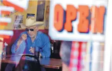  ?? MATT YORK/ASSOCIATED PRESS ?? A customer eats inside the Horseshoe Cafe in Wickenburg, Arizona. A few small businesses reopened in defiance of the state’s governor.