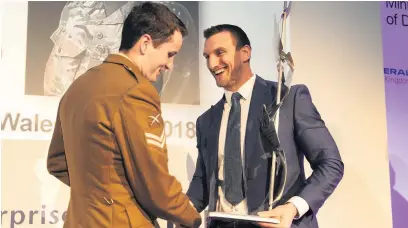  ?? Picture: Corporal Tom Evans ?? Corporal Ieuan Hudson collects his award from Sam Warburton.