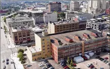  ?? TY GREENLEES / STAFF ?? A new roof is being put on the Huffman Block Building on East Third Street in the Fire Blocks District of downtown Dayton. Montgomery County commission­ers Tuesday approved spending $750,000 on redevelopm­ent of the district.