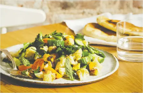  ?? PHOTOS: CARa HOWE ?? Cookbook author Lukas Volger’s roasted cauliflowe­r salad uses fresh herbs just as abundantly as other vegetables.