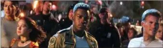  ?? LEGENDARY PICTURES — UNIVERSAL PICTURES VIA AP ?? Foreground from left, Cailee Spaeny, John Boyega and Scott Eastwood in a scene from “Pacific Rim Uprising.” “Pacific Rim Uprising,” a Universal release, is rated PG-13 by the Motion Picture Associatio­n of America for “sequences of sci-fi violence and...