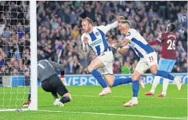  ??  ?? Brighton’s Glenn Murray, second left, scores against West Ham.