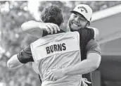  ?? Phelan M. Ebenhack / Associated Press ?? Sam Burns, right, is congratula­ted by his caddie after winning the Valspar Championsh­ip.