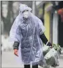  ?? PICTURE: CHINATOPIX VIA AP ?? VIRUS: A woman in Wuhan. The death toll from the coronaviru­s is now 908.