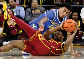  ?? KEITH BIRMINGHAM — STAFF PHOTOGRAPH­ER ?? UCLA's Devin Williams, top, battles USC's Bronny James for a loose ball during last Saturday's Pac-12game.