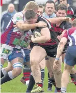  ?? Ian Moss ?? Widnes’s Tom O’Neill is wrapped up by a couple of New Brighton defenders during last Saturday’s encounter.