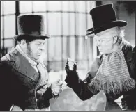  ??  ?? Reginald Owen (right) plays Scrooge with Gene Lockhart as Bob Cratchit in the 1938 film version of A Christmas Carol.