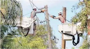  ?? JOE BURBANK/STAFF PHOTOGRAPH­ER ?? Duke Energy linemen replace a utility pole Tuesday in the Dommerich Estates neighborho­od in Maitland. Some homes in the area have not had power for more than a week.