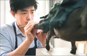  ?? PHOTOS PROVIDED TO CHINA DAILY ?? Zhang Yu carries on his family’s craftsmans­hip of clay figurine making. The owner of a gallery in Beijing and a workshop in Tianjin, he is dedicated to the evolution of the age-old craft.