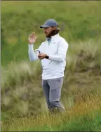  ??  ?? The Associated Press
England’s Tommy Fleetwood plays a practice round for the British Open at The Royal St George’s in Sandwich, England, on Monday.