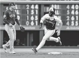  ?? JOHN LEYBA USA TODAY NETWORK ?? Rockies second baseman Brendan Rodgers rounds second base against the visiting Rangers during Saturday’s third inning.