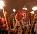  ?? REUTERS ?? Questionab­le costumes, such as Native American garb and blackface, have been part of the Guy Fawkes celebratio­ns in Lewes for decades.