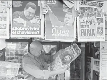  ?? Luis Robayo
Afp/getty Images ?? of Venezuela’s firebrand president, Hugo Chavez, dominated headlines at home and abroad, including in Colombia, where a man in the city of Cali, above, keeps up with the news.