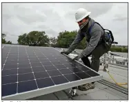  ?? (AP/Ben Margot) ?? Gen Nashimoto installs solar panels last week in Hayward, Calif. More photos at arkansason­line.com/53renewabl­e/.